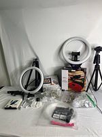 Full view of content creation items including ring lights, tripods, accessories, string lights, chargers, and packaged microphone and boombox.