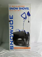 Front of retail box showing SnowJoe branding, 11" 10A electric snow shovel image, LED light and clearing depth callout.