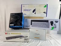 Photo showing all boxed items including condenser microphone set, gaming headphones, multifunction adapter, LED tape lights and wireless keyboard mouse combo