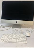 Front view of iMac with wired keyboard and mouse on table