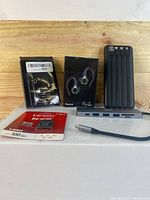 Full bundle showing all items including Lexar microSDXC card, wired and wireless earbuds, USB hub, and power bank