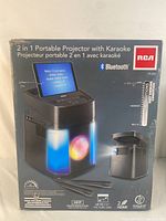 Front of product box showing karaoke and portable projector with Bluetooth capabilities and LED change light effects.