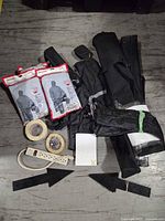 Lot overview showing tube bags, protective suit packages, tapes, power bar, arrows, notepads