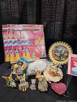 group shot of Valentines packs, fairy figures, kiwi bird, glass cat, heart dish and plate