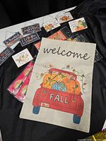 Overhead view of canvas flag, tin signs and eye mask packs