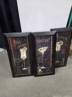 Front view of three framed cocktail signs