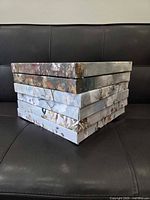 Stack of six square stretched canvas prints showing painted edges
