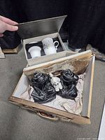 Box containing bookends, wind-up poodle, tea infuser gift set