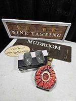 Group shot showing all items: Wine Tasting sign, Mudroom hook board, oval wine quote sign, bottle-shaped book, boxed double-wall glasses