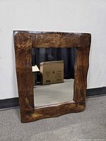 front view of rectangular wavy-edge wood framed mirror