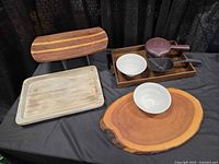 All items grouped: four wooden trays, two white bowls, Pampered Chef steamer and scoop