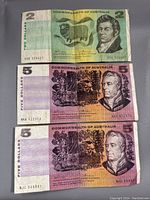 Front and back of $2 Australian bill with portrait and sheep image