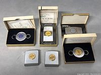 Six collectible ZIPPO pocket tools displayed including tape measures, lighters, and circular keychain style tools with gold leaf and company logos in original boxes.