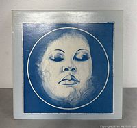 Front cover of Billie Holiday vinyl album with blue and white stylized portrait artwork.