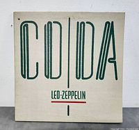 Front of the vinyl record sleeve with title 'CODA LED ZEPPELIN' printed in green and red on white background.