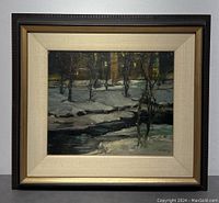 Full front view of the original painting in its frame showing the winter night scene with snow, stream, and buildings.