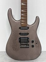Front view showing metallic textured solid body guitar with three pickups, two volume/tone knobs and toggle switch.