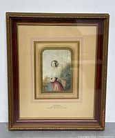 Full view of the framed print showing the image and matting in a wooden and gold detailed frame.