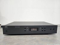 Front view of the NAD Model 412 Stereo Tuner showing digital frequency display and control buttons.