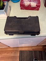 Closed black hard plastic carrying case labeled Cordless.