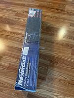 Full photo of the sealed box with the name Mastercraft Folding Work Bench visible