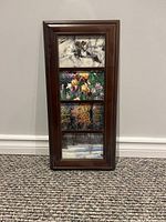 Front view of the vertical wooden framed photos showing four images of wildlife and natural scenes.