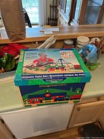 Original box of Imaginarium Ultimate Train Set placed on kitchen counter, unopened with lid closed.