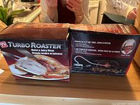 Photo of Turbo Roaster box showing product branding, cooking results, and claims of faster cooking time.