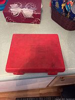 Closed view of the red plastic carrying case containing the wrench set