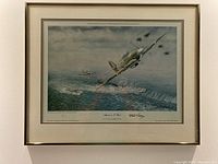 Framed print showing a detailed aerial attack scene with two planes and an E-boat.