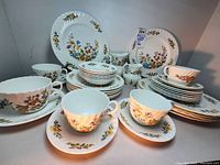 Overall view of plates, cups, saucers and pitchers arranged together
