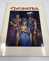 Front cover of the Cleopatra 1963 movie press book with title in red and central color image.