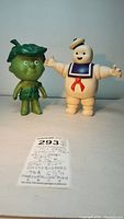 Photo of both Little Green Sprout and Stay-Puft Marshmallow Man figures with identification tag