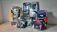 Photo showing multiple unopened vintage Zamboni collectibles stacked and arranged, highlighting Toronto Maple Leafs and other team branded boxed items and two sealed NHL player cards of Vesa Toskala and Eric Lindros.