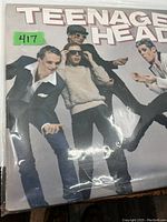 Front cover of Teenage Head 1979 punk debut LP showing band members posing dynamically with the band name in large font at the top.