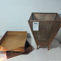 Two wooden letter trays with medium brown stain next to a tall woven waste paper basket