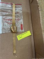 Watch and mesh bracelet laid flat in box with P.A. Freeman bag in background