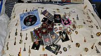 Mixture of carded and loose Hard Rock Café enamel pins displayed on a towel, showing overall variety.
