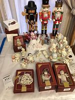Wide shot showing three large nutcrackers, boxed ornaments, unboxed Snowpeople figurines and Grinch ornament