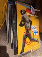 Stack of vintage magazines including two yellow Olympia Helsinki 1952 magazines featuring a male athlete running; the covers show wear and minor tears.