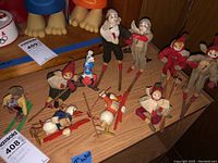 Group of ten skiing figurines on shelf