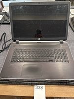 Front view of the HP Pavilion 17 inch laptop with the screen off and keyboard visible.
