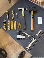 Full lot of tools laid out on black surface showing all included items.