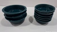 Stacked view of 3 cereal bowls (left) and 6 soup bowls (right) in teal green-blue color with glossy finish.