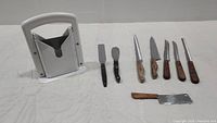 Full set including six knives, two spreaders, small cleaver, and bagel slicer.