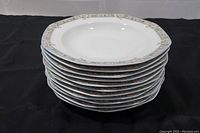 Stack of eleven Studio Nova French Villa pattern bowls showing the octagonal shape and floral rim.