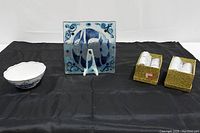 Front view of all items in the lot: Meissen Blue bowl, fused glass mosaic plate on stand, and two boxes of Spode Kitchen Butterfly napkin rings.
