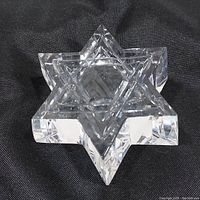 Oblique top view of the Waterford crystal Star of David paperweight emphasizing the clarity and geometric facets.