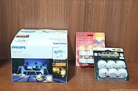 Lot showing the three different packs of battery-operated tea light candles including Philips tea lights, holiday flameless tea lights, and everlasting tea lights in packaging.