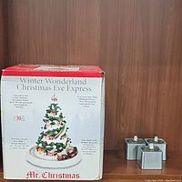 Boxed Winter Wonderland Christmas Eve Express ceramic Christmas tree with mini train and illuminated houses and musical features.